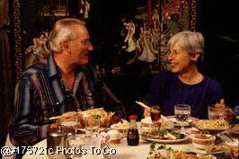 Mature adult couple eating Chinese food